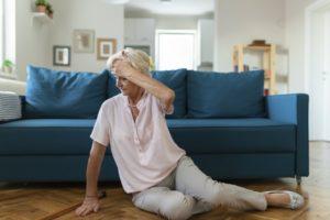 Elderly lady sitting on floor