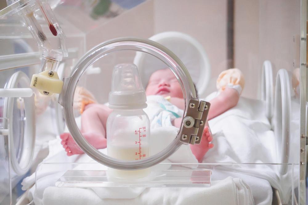 a premature baby with a bottle of formula